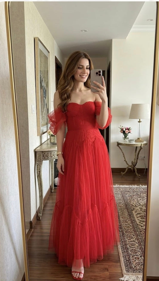 Back view of stylish red off-shoulder tulle party gown highlighting flowy silhouette